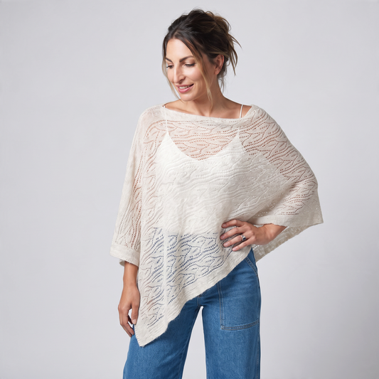 Trebor Style off-white mohair blend open-work poncho worn by a woman with blue jeans