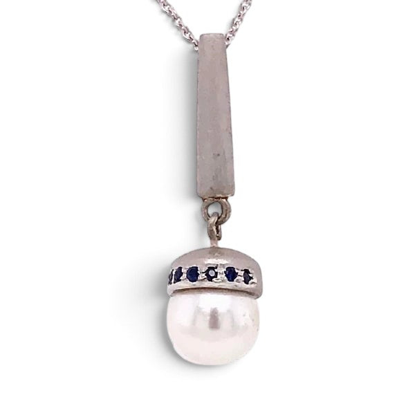 Trebor Style Akoya pearl pendant necklace with blue sapphire accents on a brushed sterling silver bale and chain.