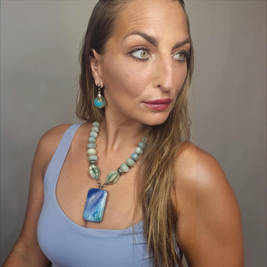 Trebor Style Masha Archer necklace with aquamarine quartz, jade, and a marbled glass pendant worn by a woman