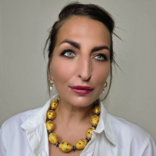 Trebor Style Masha Archer Cameroon gold wreath necklace featuring 24k gold plated bronze baskets and black enamel discs.