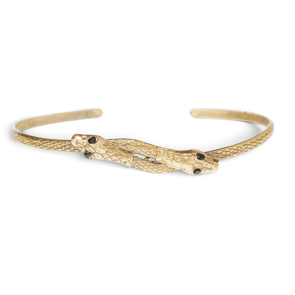 Trebor Style thin double serpent bangle in reclaimed gold-tone metal with Austrian crystal eyes on a white background