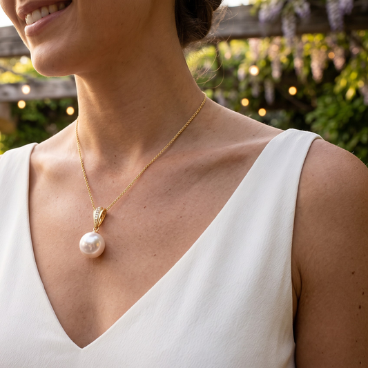 Trebor Style 18k gold pendant necklace featuring a large round Edison pearl and diamond accents on a delicate chain.