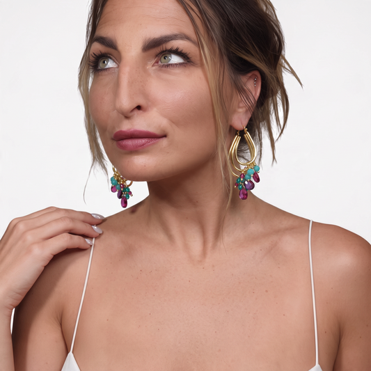Trebor Style Jalila gold-plated 925 silver earrings with fuchsia and turquoise stones worn by a woman.