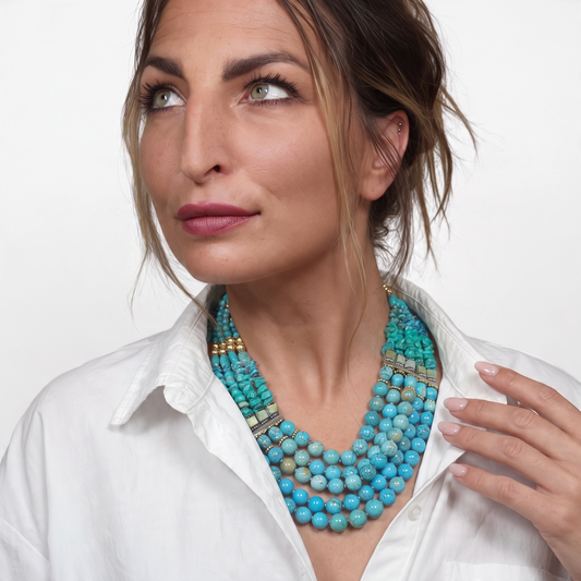 Trebor Style Masha Archer 5-strand necklace with blue magnesite, turquoise beads, and gold accents on a woman