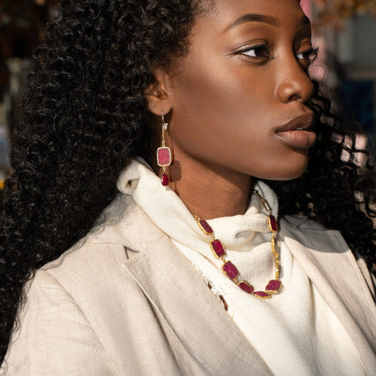 Trebor Style Longevity earrings featuring raw ruby slabs and garnet drops on 14k gold-filled chain worn by a model.