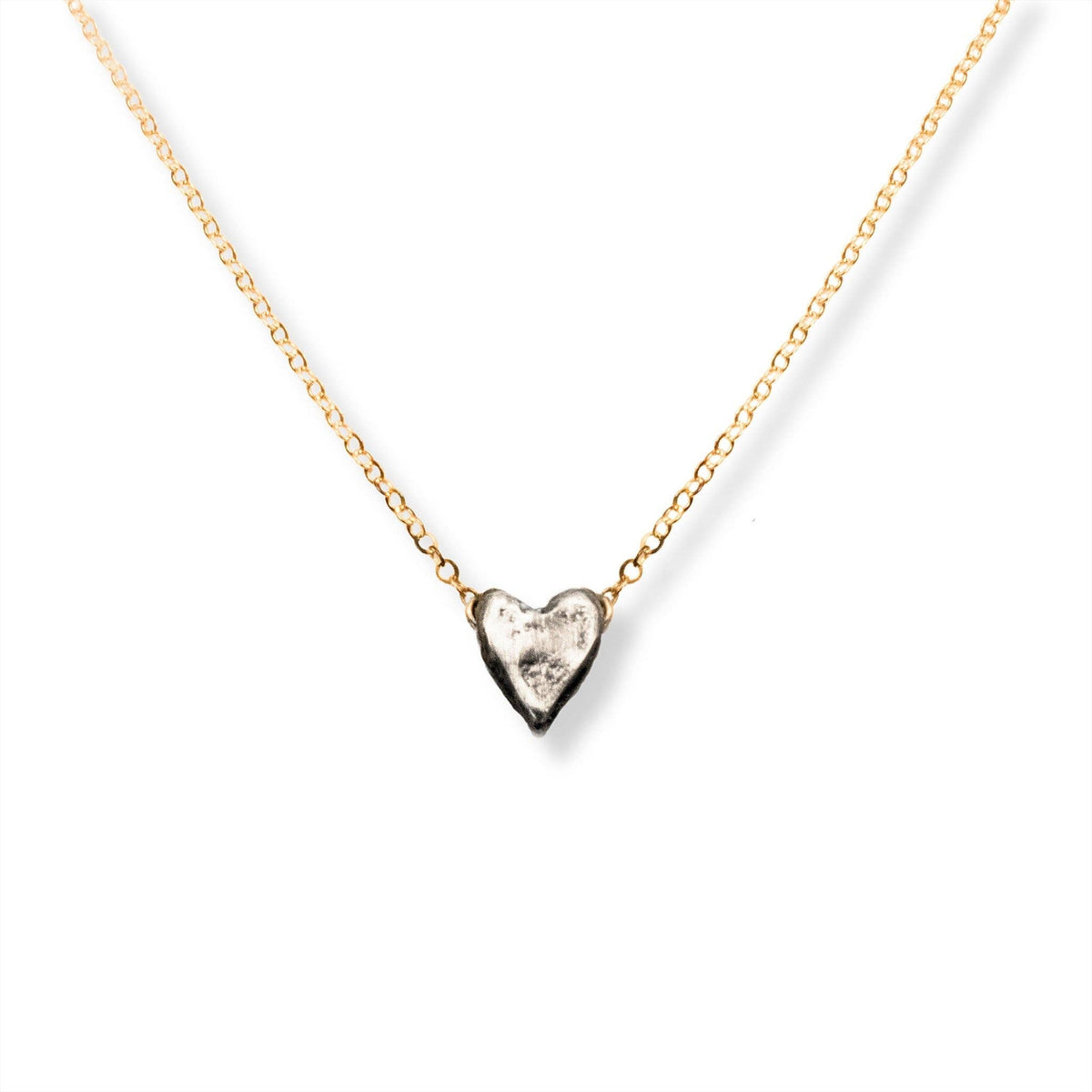 Trebor Style dainty heart necklace featuring a recycled sterling silver heart pendant on a 14kt gold-filled chain.