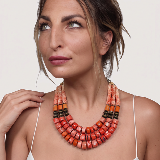 Trebor Style Masha Archer triple strand necklace featuring orange coral rondelles, pewter beads, and floral accents.