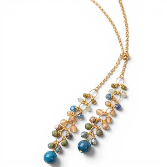 Trebor Style waterfall lariat necklace featuring blue kyanite, crystal, and Czech glass beads on a matte gold chain.