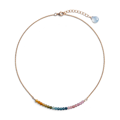 Trebor Style sterling silver necklace featuring a delicate chain and a curved bar of multi-colored tourmaline beads.