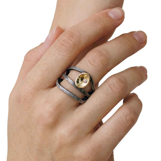 Trebor Style sterling wrap ring with textured oxidized silver band, 14k gold cup, and cognac brown diamond on finger