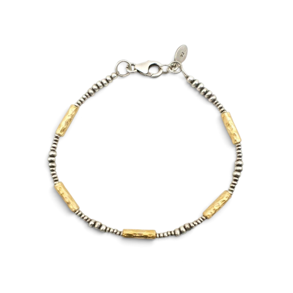 Trebor Style hammered 14K vermeil tube and sterling silver bead bracelet with lobster clasp on marble background.
