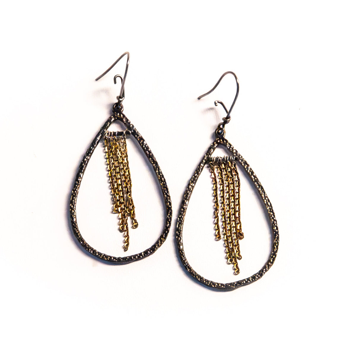 A pair of teardrop-shaped dangle earrings with dark oxidized metal frames and gold-tone chain fringe, shown on a plain white background.