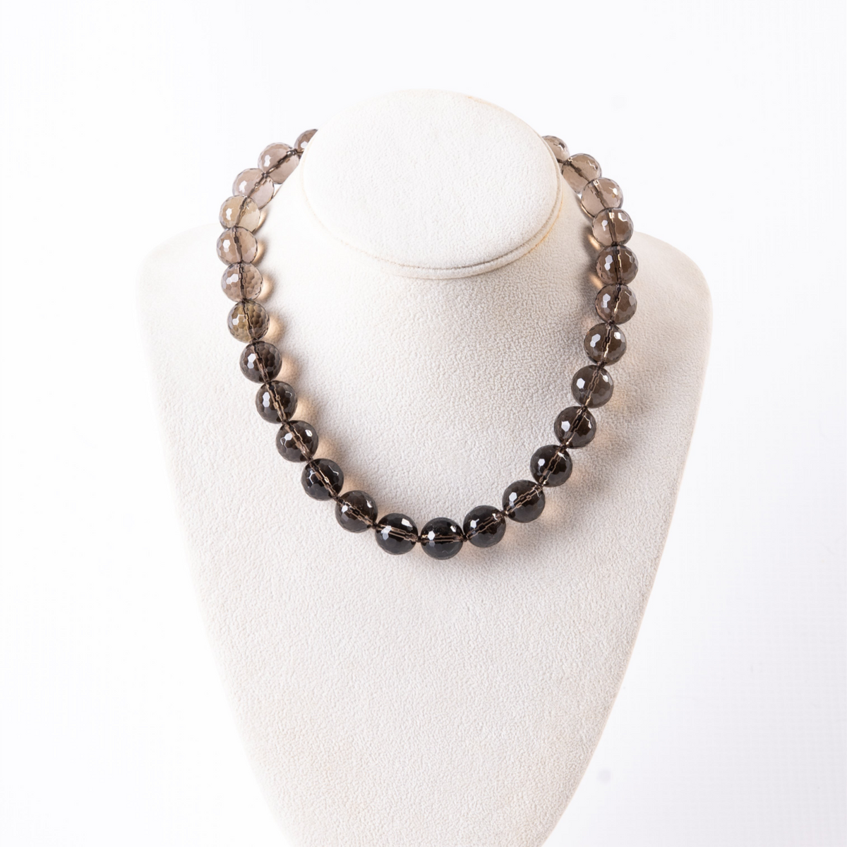 Trebor Style faceted smokey quartz beaded necklace with 18k gold clasp on a white display bust