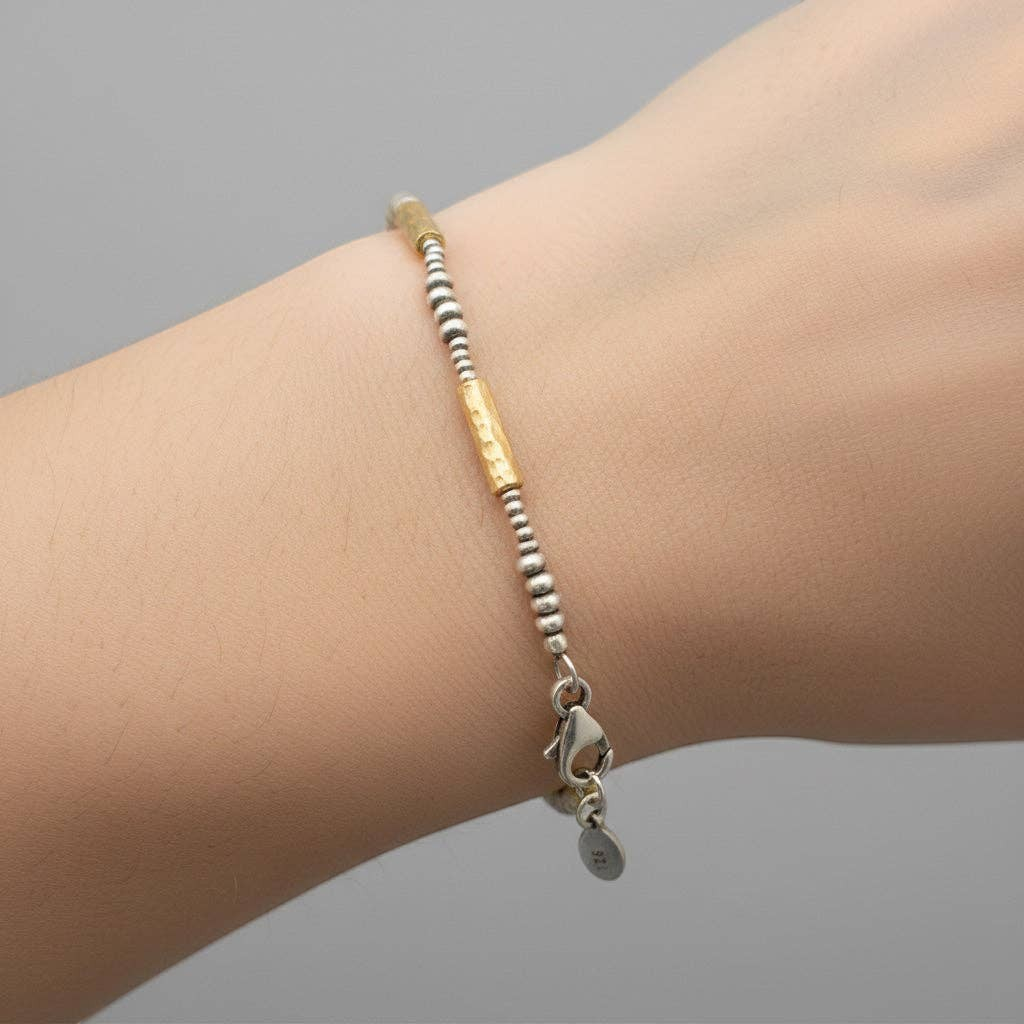 Trebor Style hammered 14k vermeil and sterling silver mixed metal bracelet worn on a wrist