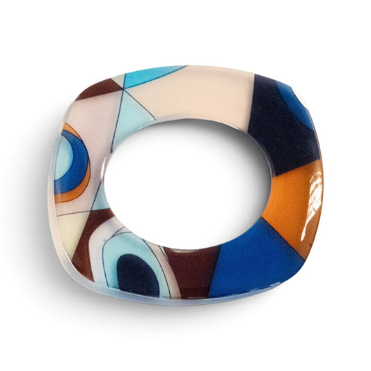 Trebor Style flat acrylic bangle featuring a hand-painted abstract motif in blue, caramel, and black triangular shapes.