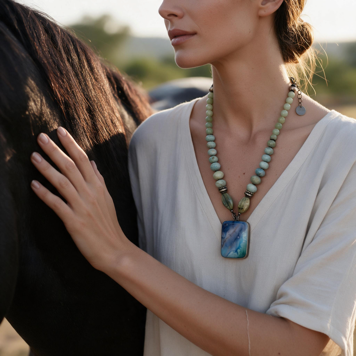 Trebor Style Masha Archer necklace with aquamarine quartz, jade, and a marbled glass pendant worn by a woman.