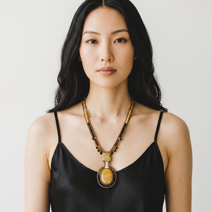 Trebor Style Arkanis long bumblebee necklace featuring yellow jasper, bronze, gold, and black beads on a model