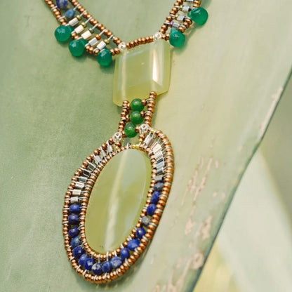 Trebor Style Arkanis necklace featuring a large green vesuvianite pendant with jade, lapis, and murano glass beads.