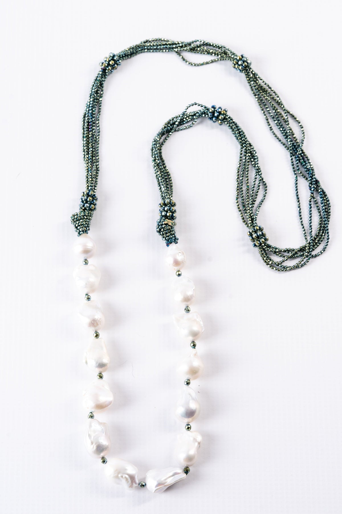 Trebor Style long necklace featuring large white baroque pearls and multi-strand green hematite seed beads.