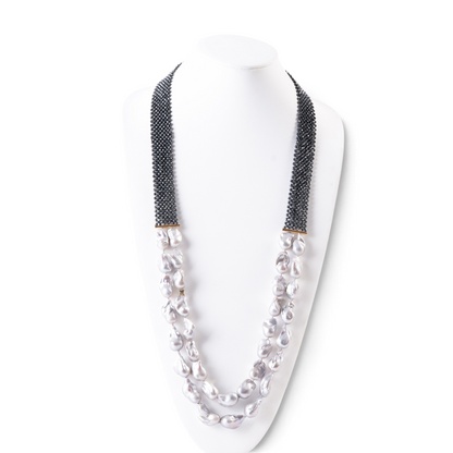 Trebor Style double strand necklace featuring grey baroque pearls, faceted hematite beads, and an 18k gold bar accent.