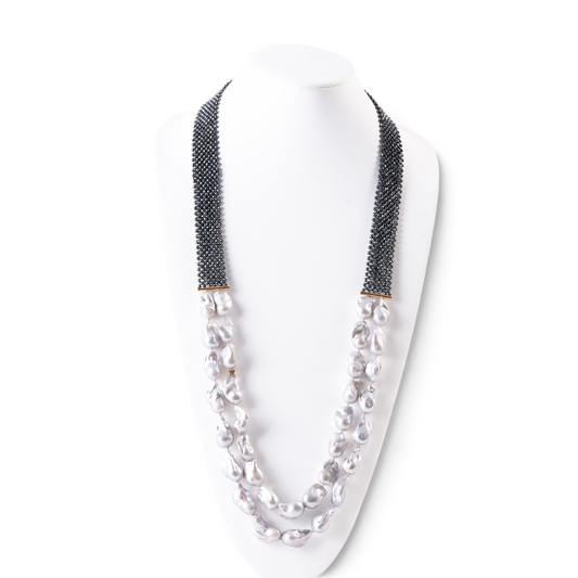 Trebor Style double strand necklace featuring grey baroque pearls, faceted hematite beads, and an 18k gold bar accent.