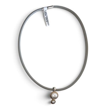 Trebor Style Bastian double drop white cultured pearl pendant necklace on a grey leather cord with two-tone metal.
