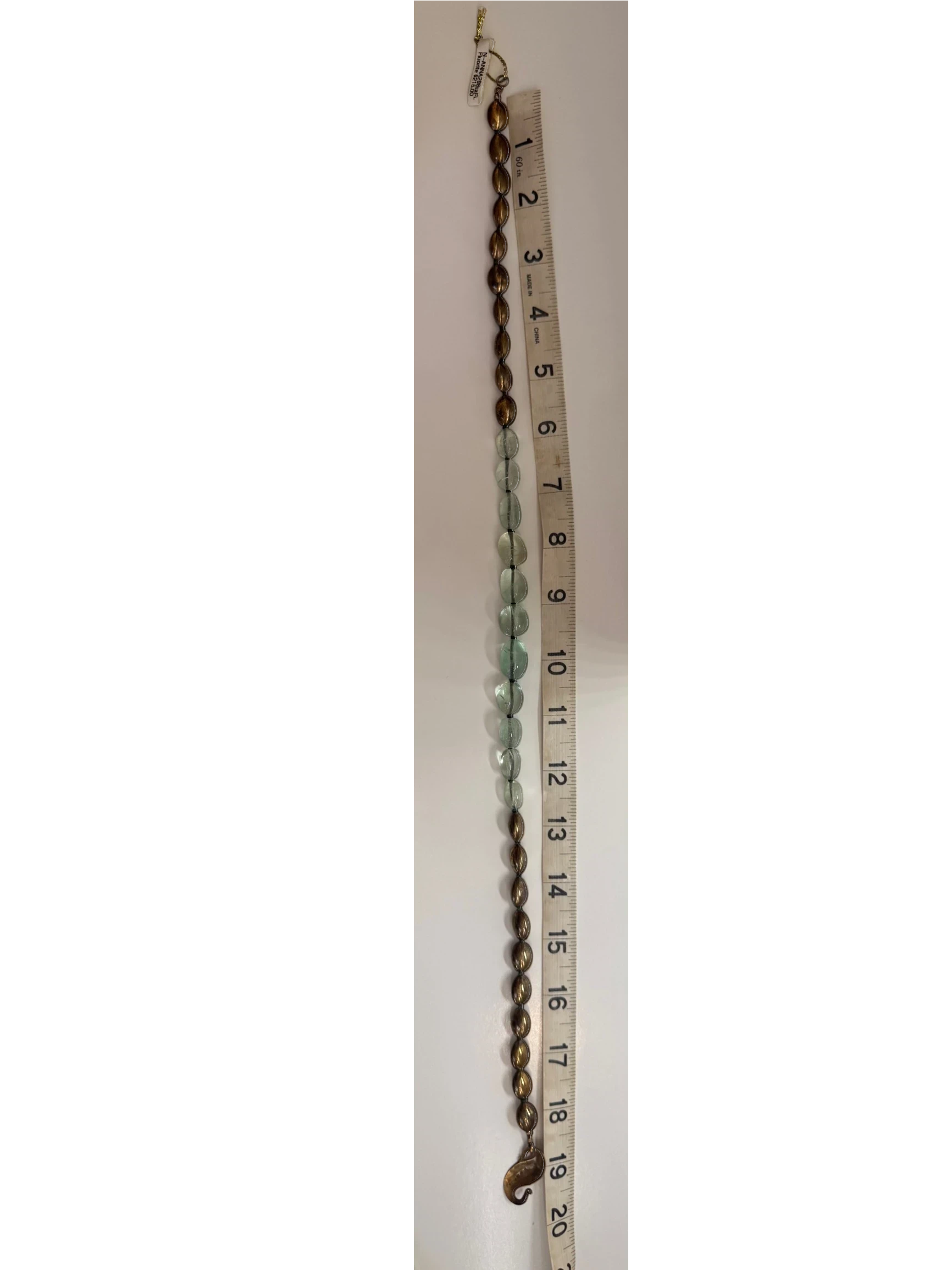 Trebor Style handcrafted statement necklace featuring pale green fluorite beads and metallic bronze oval accents.