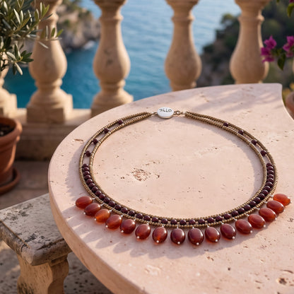 Trebor Style multi-strand beaded necklace with bronze seed beads, garnet accents, and dangling carnelian-style beads.