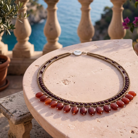 Trebor Style multi-strand beaded necklace with bronze seed beads, garnet accents, and dangling carnelian-style beads.