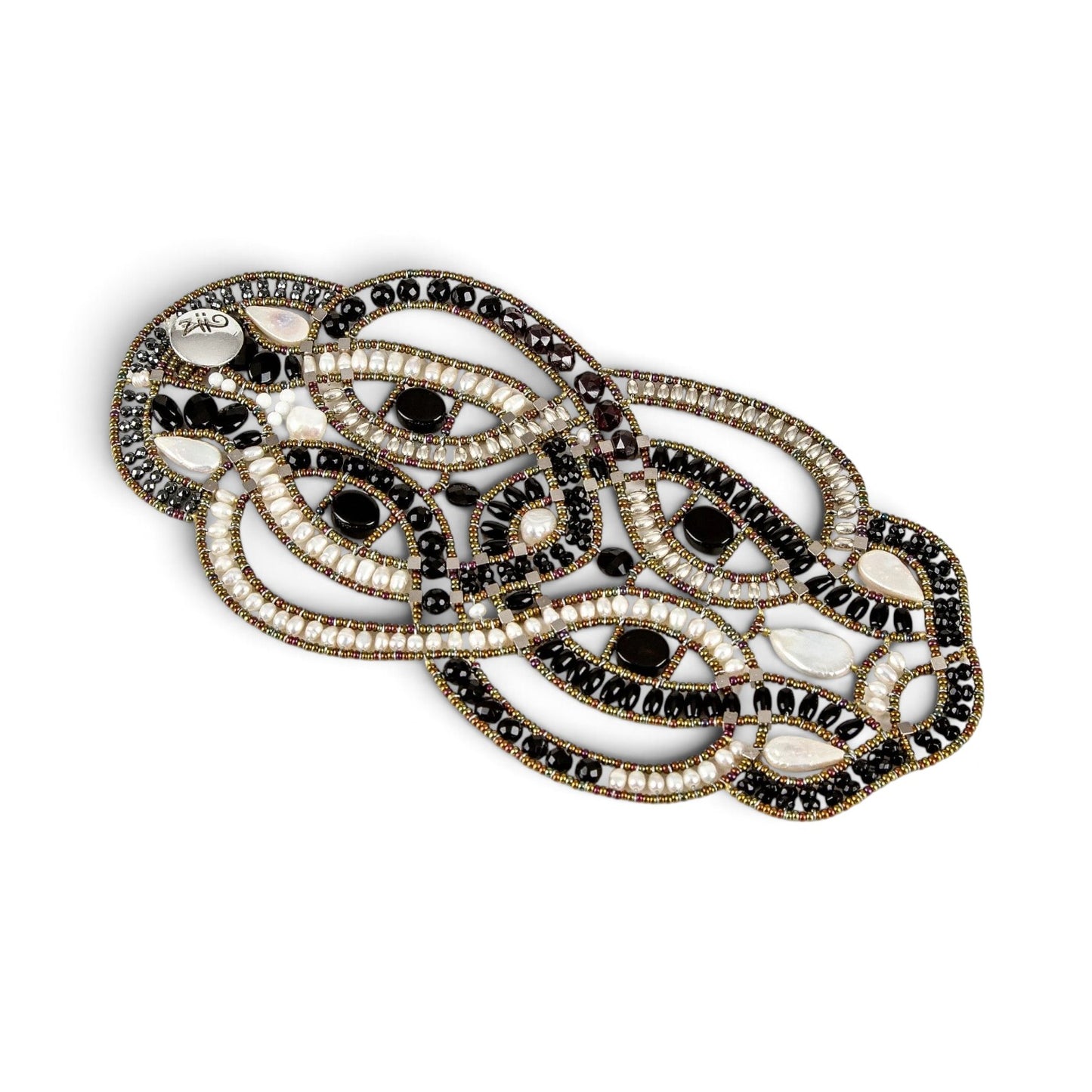 Trebor Style artisan statement bracelet featuring woven black onyx beads, white freshwater pearls, and metallic accents.