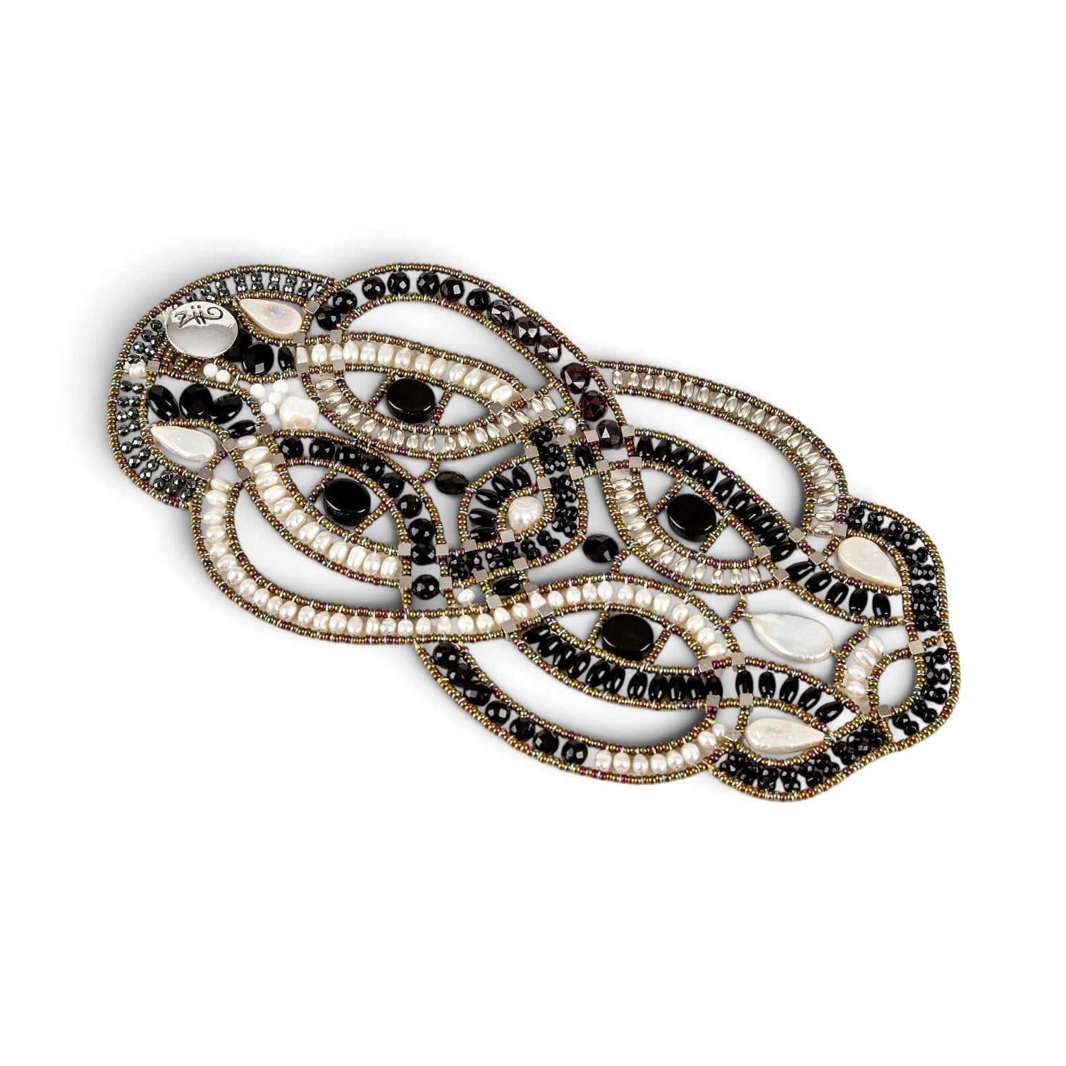 Trebor Style artisan statement bracelet featuring woven black onyx beads, white freshwater pearls, and metallic accents.