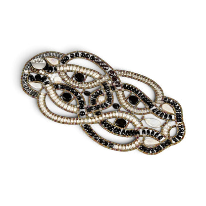 Trebor Style artisan statement bracelet featuring woven black onyx beads, white freshwater pearls, and metallic accents.