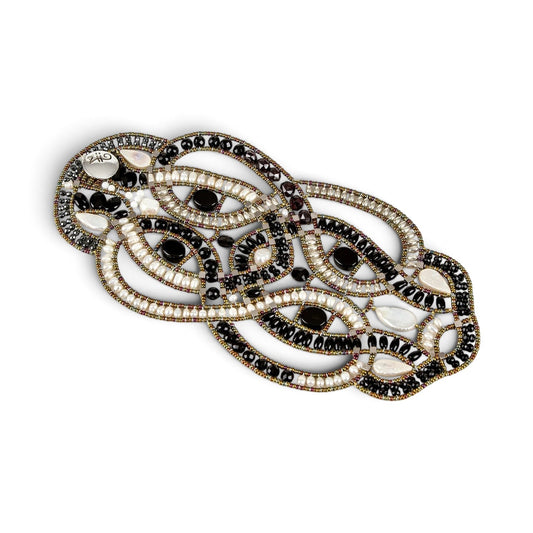 Trebor Style artisan statement bracelet featuring woven black onyx beads, white freshwater pearls, and metallic accents.