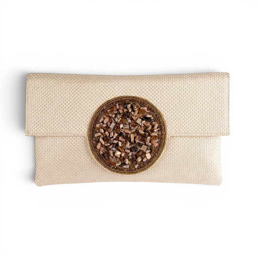 Trebor Style beige jute silk clutch featuring a central hand-embellished medallion with natural stone accents.