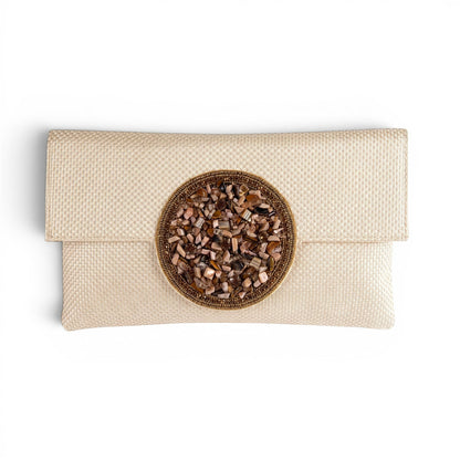 Trebor Style beige jute silk clutch featuring a central beaded medallion in gold, peach, grey, and cream tones.
