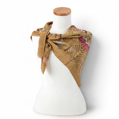 Trebor Style beige silk crepe square scarf with jungle print in gold, tan, pink, and blue on a mannequin