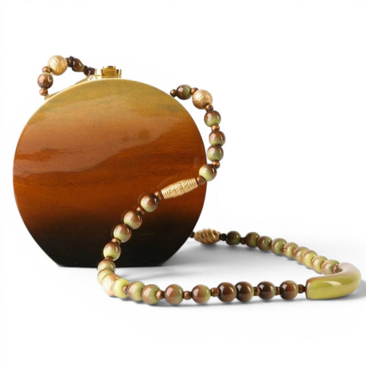 Trebor Style Timmy Woods Binn circular acacia wood handbag with high-gloss lacquer and beaded shoulder strap.