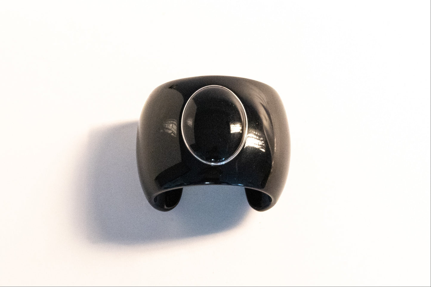 Trebor Style black acrylic cuff bracelet featuring a large oval black onyx cabochon set in sterling silver.