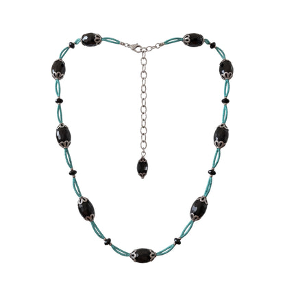 Trebor Style necklace with faceted black agate ovals, silver filigree caps, and turquoise thread on a silver chain.
