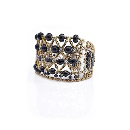 Trebor Style wide cuff bracelet featuring intricate black faceted beads and metallic gold lattice-work detailing.