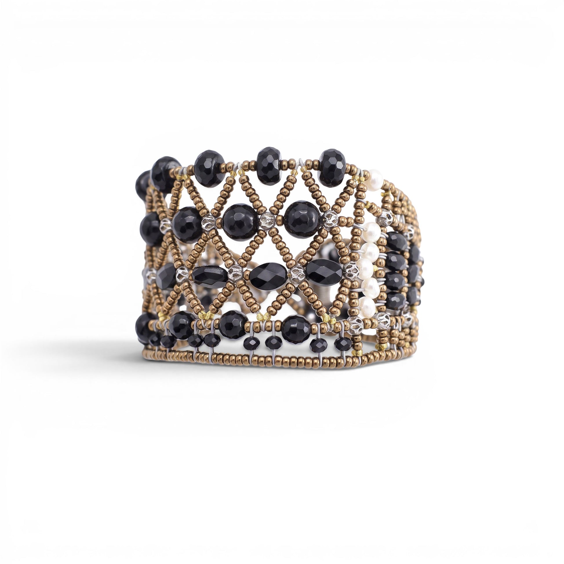 Trebor Style wide cuff bracelet featuring intricate black faceted beads and metallic gold lattice-work detailing.