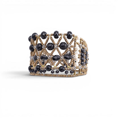 Trebor Style wide cuff bracelet featuring intricate black faceted beads and metallic gold lattice-work detailing.