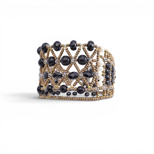 Trebor Style wide cuff bracelet featuring intricate black faceted beads and metallic gold lattice-work detailing.