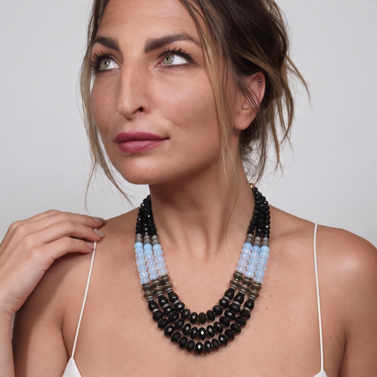 Trebor Style Masha Archer three-strand statement necklace with black onyx, opalite milkglass, and gold-plated beads.