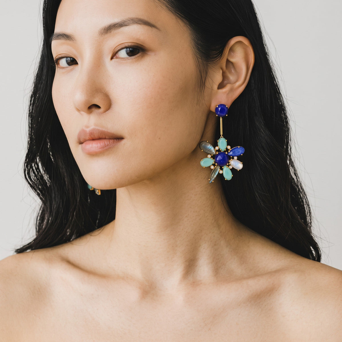 Trebor Style blue hibiscus flower earrings featuring kyanite, lapis lazuli, and aquamarine on 22k gold plated metal.