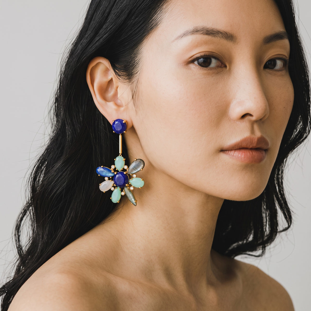 Trebor Style blue hibiscus earrings featuring kyanite, lapis lazuli, and aquamarine stones on 22k gold plated metal.