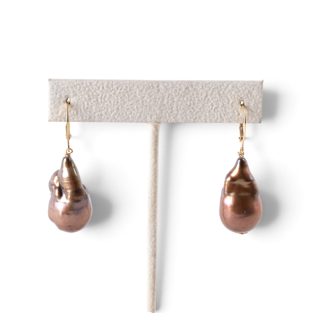 Trebor Style bronze baroque freshwater pearl drop earrings with 18k gold lever backs on a display stand