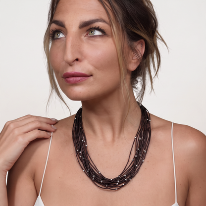 Trebor Style brown sterling silver thread choker necklace with silver beads worn by a woman against a white background