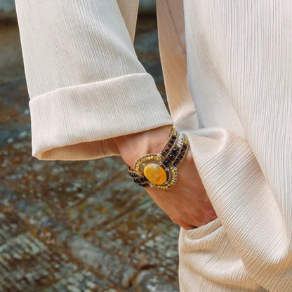 Trebor Style Arkanis oval Bumblebee Jasper cuff bracelet with agate, spinel, Murano glass, and pearl on a wrist.