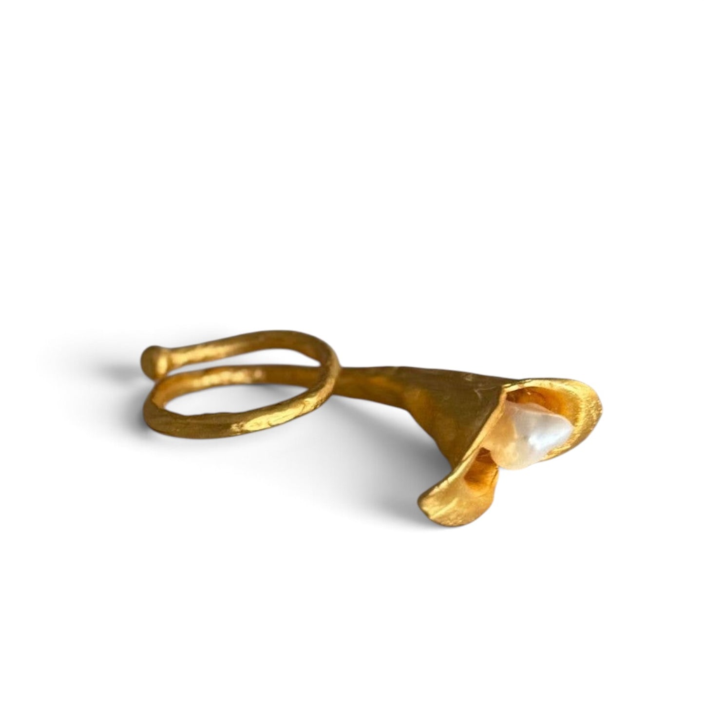 Trebor Style calla lily ring in 24k gold filled with a lustrous biwa pearl and brushed finish on a marble surface.